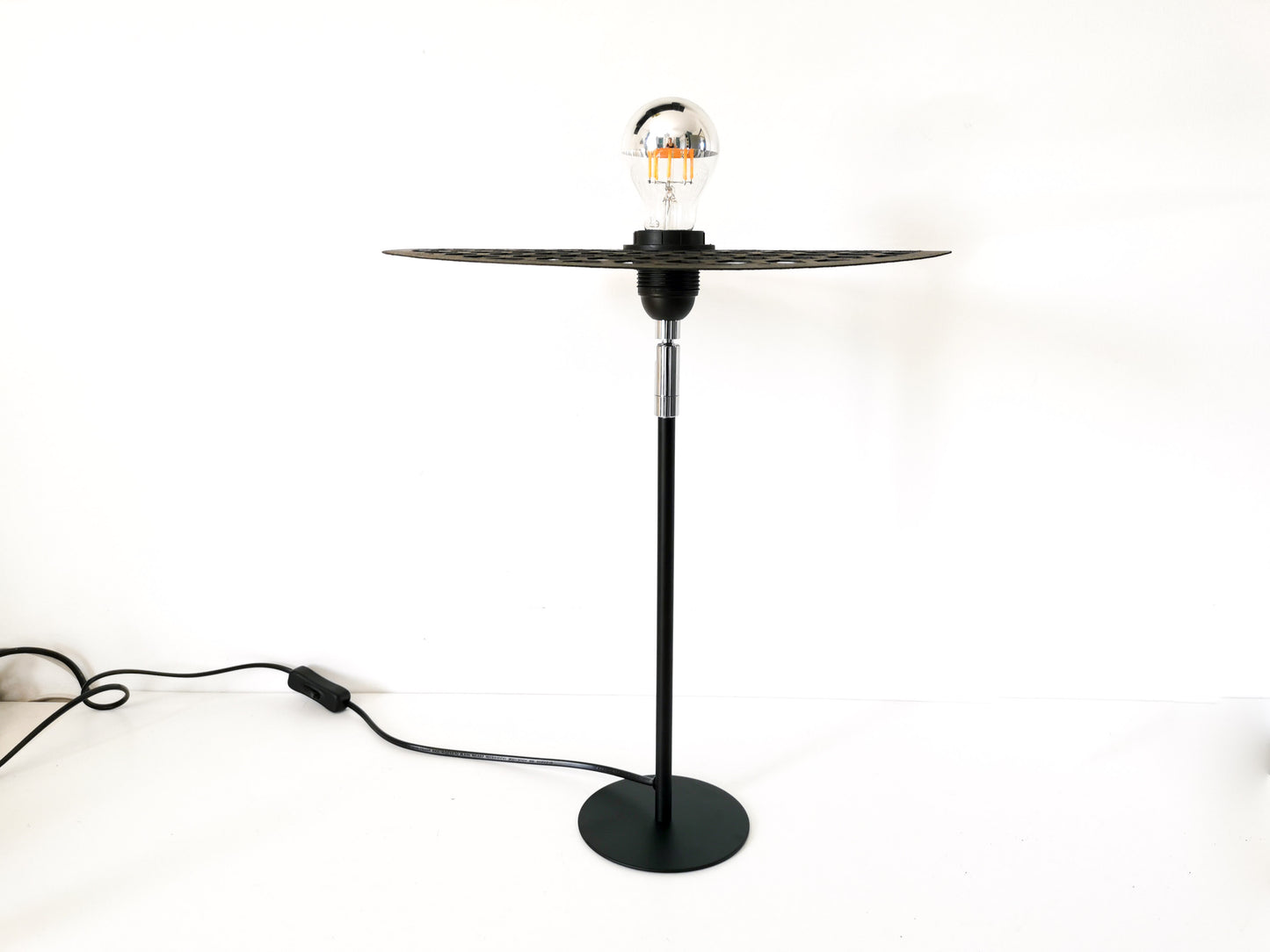 Une Lampe Articulé noire avec un design "nid d'abeille".